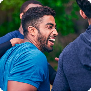 a man smiling with his friend