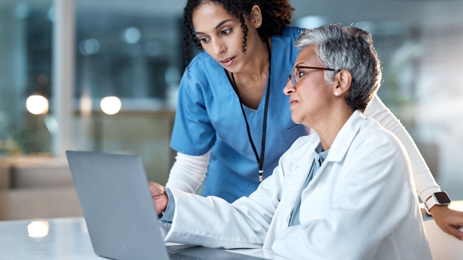 Two female clinicians looking at a computer