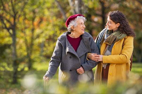 young and older woman walking outdoors