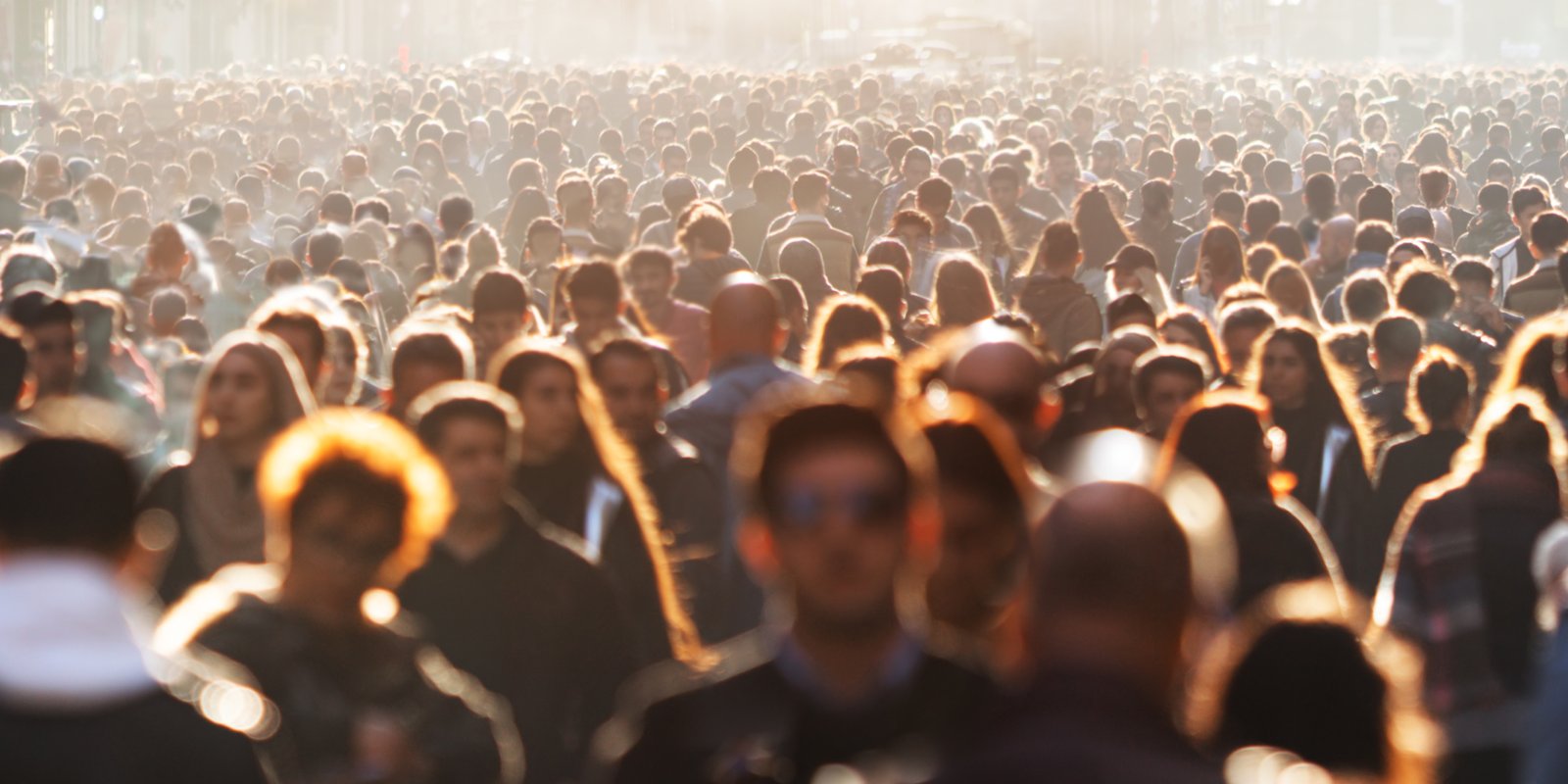 A lot of people, men, women on the street walking