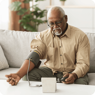 older man measuring his blood pressure at home