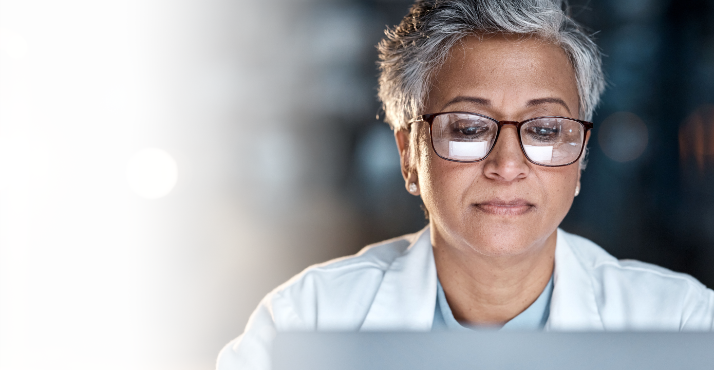 Close up of female doctor looking at her laptop