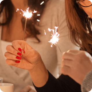 a woman holding sparklers